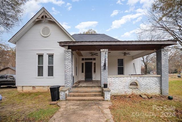 view of front facade with a porch, ceiling fan, and a front lawn