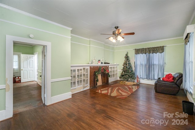 sitting room featuring ceiling fan, dark hardwood / wood-style flooring, and ornamental molding