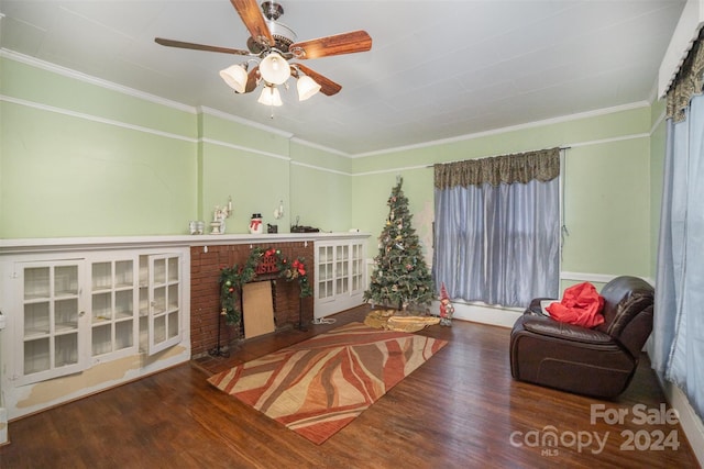 living room featuring crown molding, ceiling fan, and hardwood / wood-style flooring