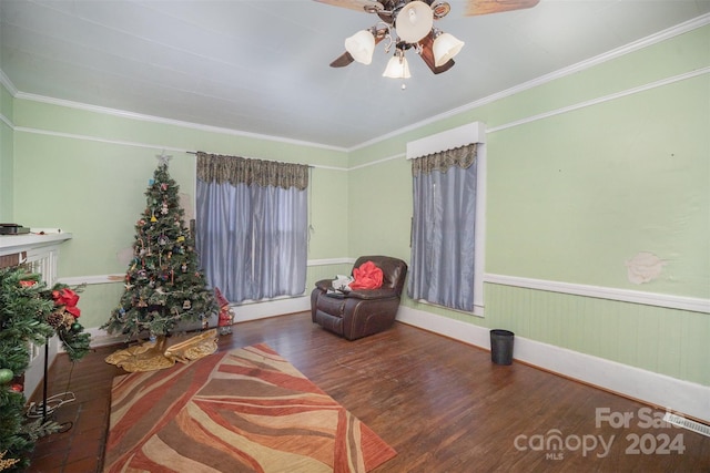 sitting room with crown molding, hardwood / wood-style floors, and ceiling fan