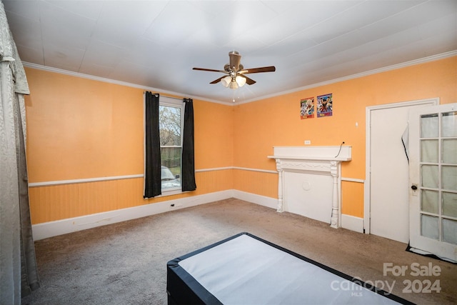 spare room with ceiling fan, carpet floors, and ornamental molding