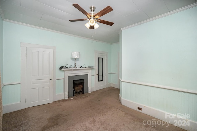 unfurnished living room with carpet flooring, ceiling fan, and crown molding