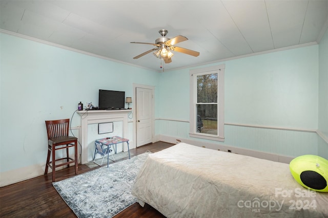 bedroom with ceiling fan, crown molding, and dark wood-type flooring