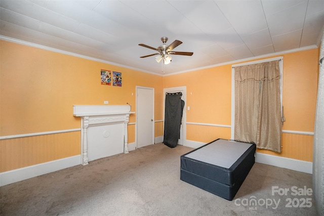 interior space featuring crown molding, ceiling fan, and carpet