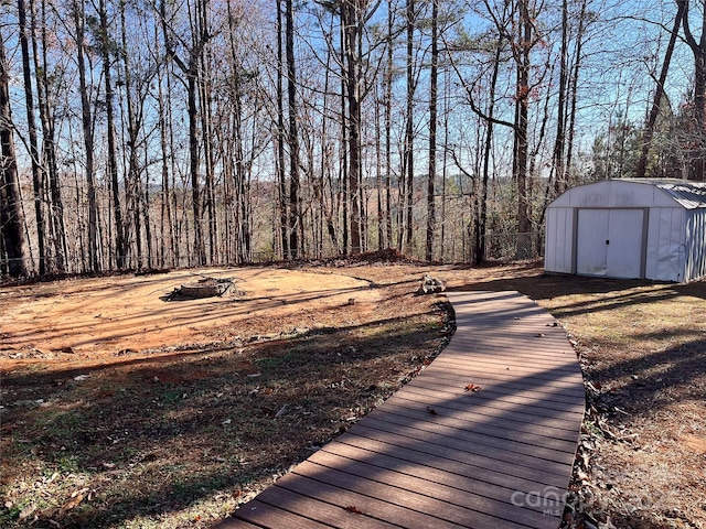 view of yard with a shed and a fire pit