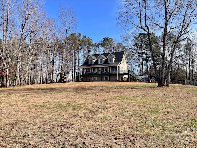 view of front of house with a deck and a front yard