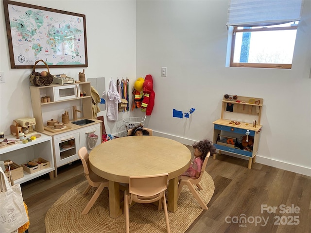 recreation room featuring dark wood-type flooring