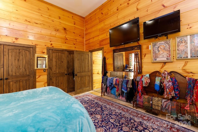 bedroom featuring wood walls