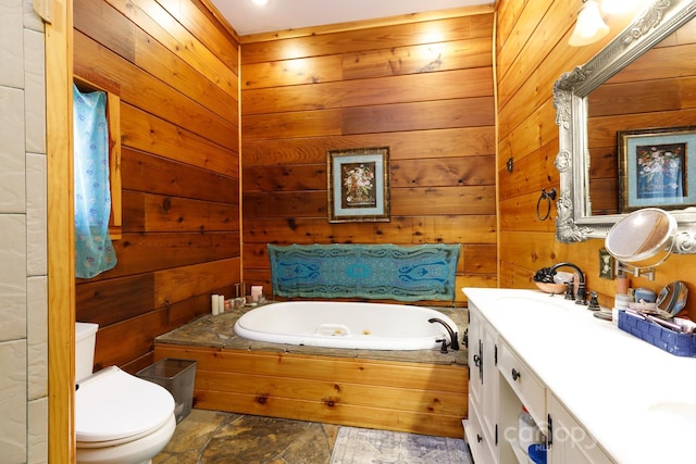 bathroom featuring vanity, a tub to relax in, toilet, and wood walls