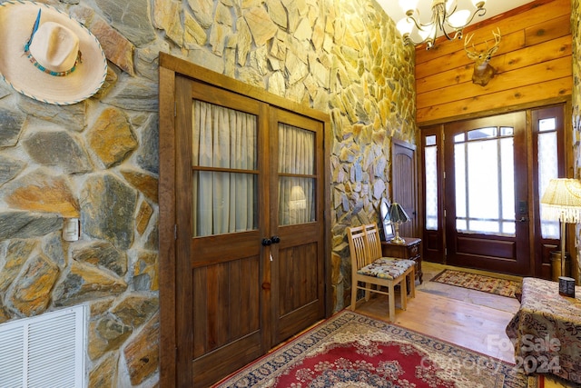 foyer with hardwood / wood-style floors and a notable chandelier