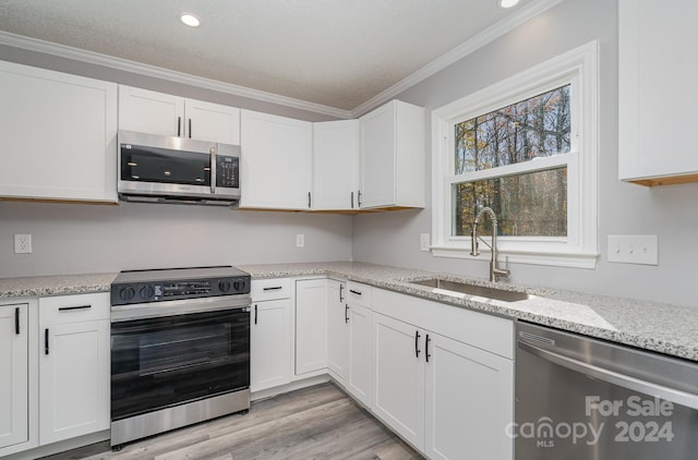 kitchen featuring white cabinetry, sink, and appliances with stainless steel finishes