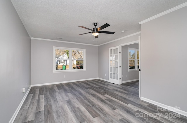 empty room featuring crown molding, ceiling fan, wood-type flooring, and a textured ceiling