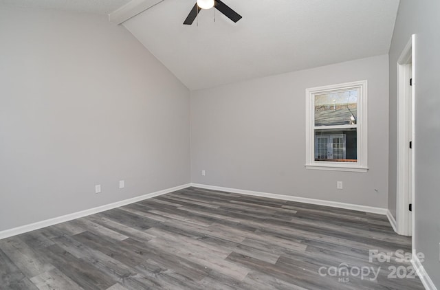 spare room featuring vaulted ceiling with beams, dark hardwood / wood-style floors, and ceiling fan