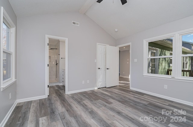 unfurnished bedroom featuring hardwood / wood-style floors, lofted ceiling with beams, a textured ceiling, and ceiling fan