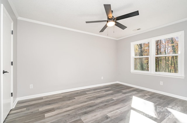 empty room with hardwood / wood-style floors, a textured ceiling, ceiling fan, and ornamental molding