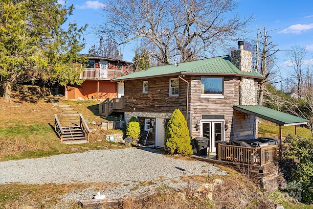 back of house with a deck