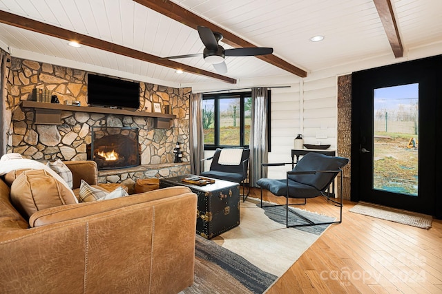 living room with wood ceiling, ceiling fan, beam ceiling, hardwood / wood-style flooring, and a fireplace