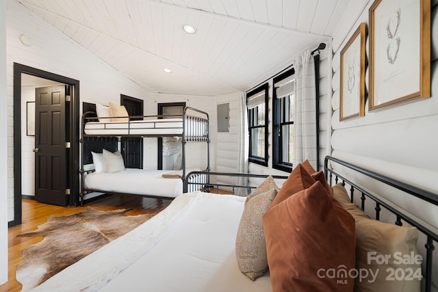 bedroom with electric panel, wood ceiling, lofted ceiling, and light wood-type flooring