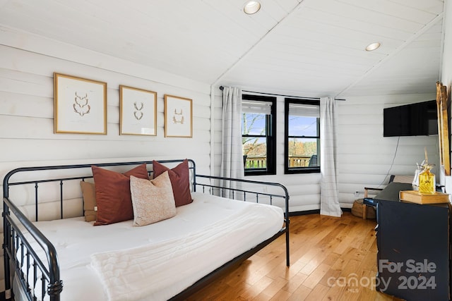 bedroom with hardwood / wood-style floors, wooden ceiling, and lofted ceiling