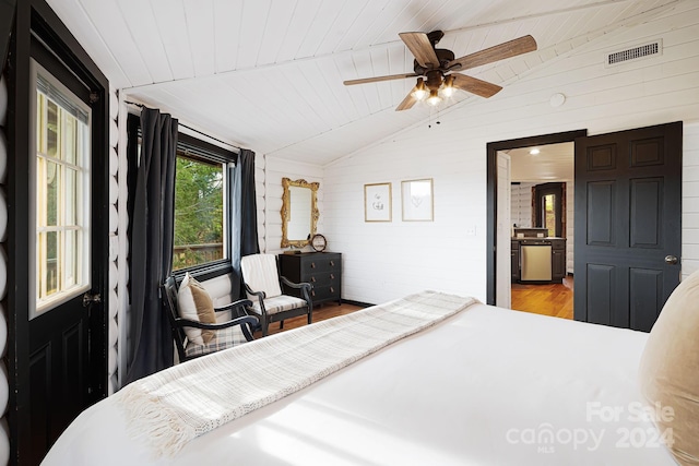 bedroom with ceiling fan, wooden ceiling, brick wall, wood-type flooring, and vaulted ceiling