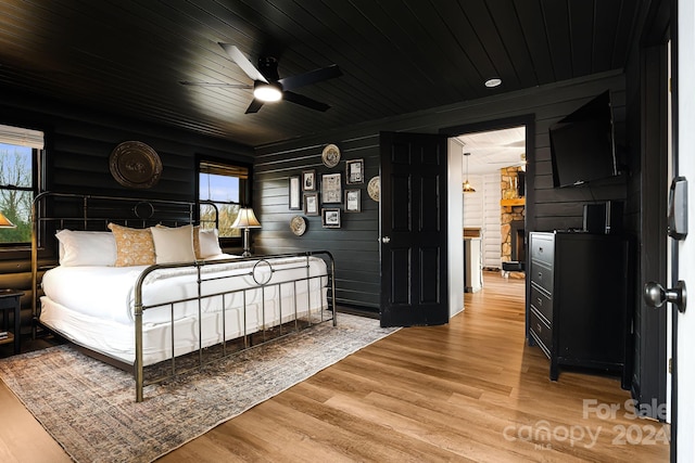 bedroom with ceiling fan, wooden ceiling, and light hardwood / wood-style flooring