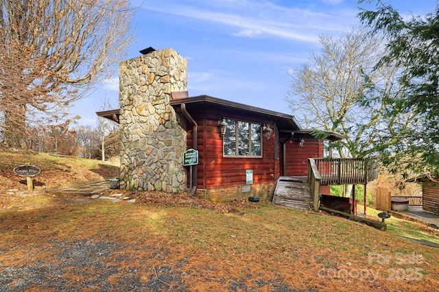 view of property exterior with a wooden deck