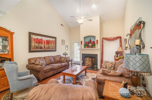 living room with wood-type flooring, high vaulted ceiling, and ceiling fan