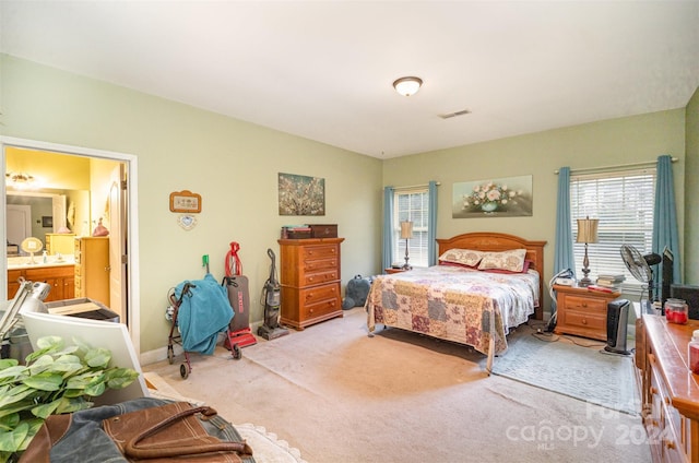 carpeted bedroom with ensuite bath