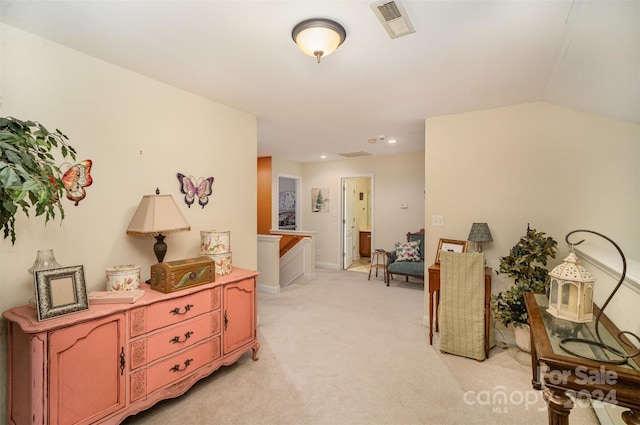 hall featuring light colored carpet and vaulted ceiling