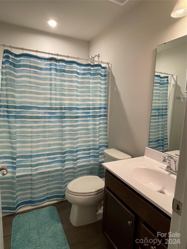 full bathroom with vanity, toilet, and shower / bath combo with shower curtain