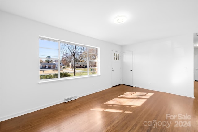 unfurnished room featuring hardwood / wood-style flooring