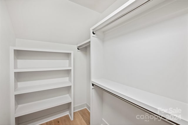 spacious closet with light hardwood / wood-style flooring