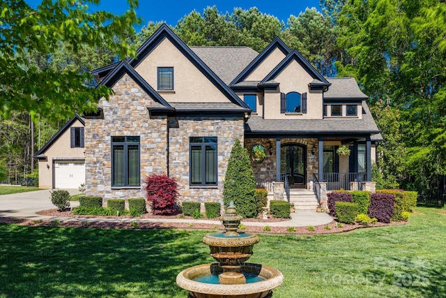 view of front facade with driveway, a front yard, a porch, and stucco siding