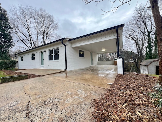 exterior space featuring a shed and a carport