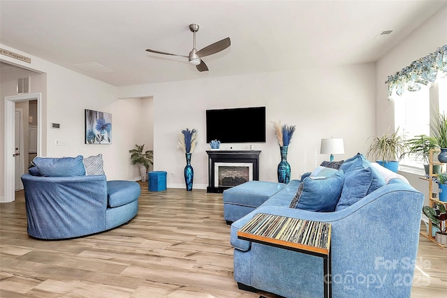 living room with ceiling fan and hardwood / wood-style floors