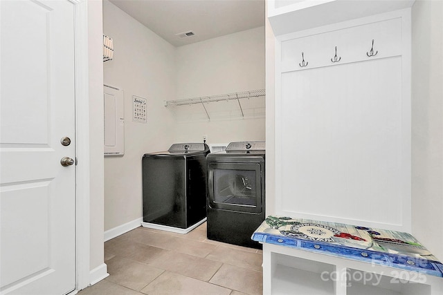 laundry room featuring light tile patterned flooring and separate washer and dryer