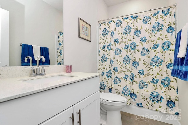 bathroom with vanity, tile patterned flooring, and toilet