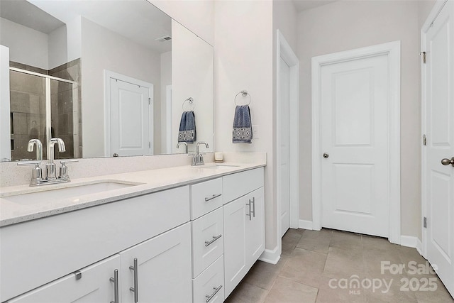 bathroom with tile patterned flooring, vanity, and an enclosed shower