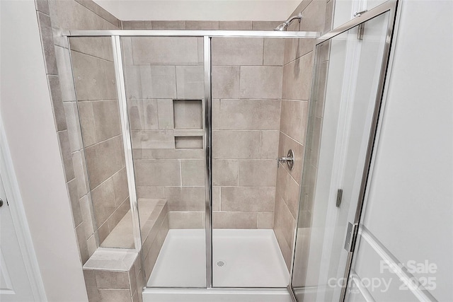 bathroom with a shower with shower door