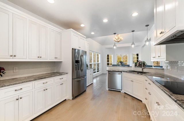 kitchen featuring white cabinetry, sink, stainless steel appliances, light hardwood / wood-style flooring, and decorative light fixtures