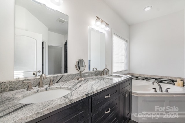 bathroom with vanity and a bathtub