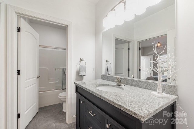 full bathroom featuring shower / bath combination with glass door, tile patterned floors, vanity, and toilet