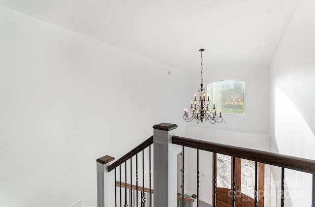 staircase with lofted ceiling, french doors, and a chandelier