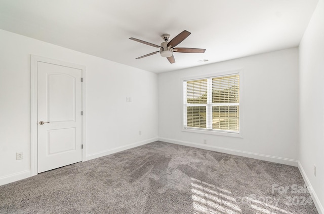 empty room featuring carpet flooring and ceiling fan