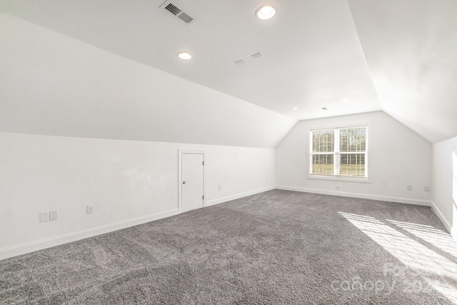 additional living space with carpet and vaulted ceiling