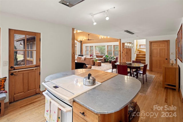 kitchen with hanging light fixtures, light hardwood / wood-style floors, ceiling fan with notable chandelier, and white electric stove