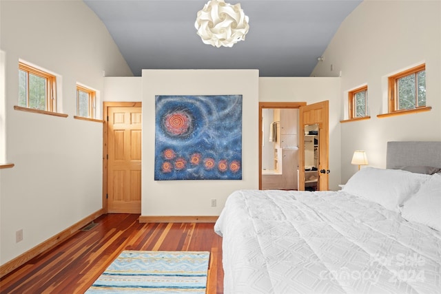 bedroom featuring wood-type flooring, connected bathroom, high vaulted ceiling, and a notable chandelier