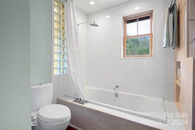 bathroom with shower / bath combo and toilet