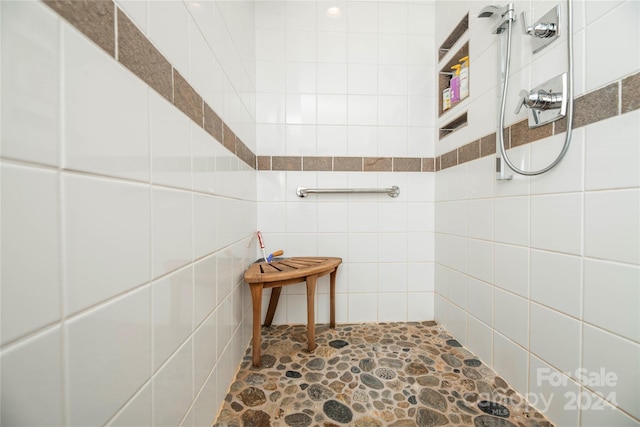 bathroom featuring tile walls and walk in shower