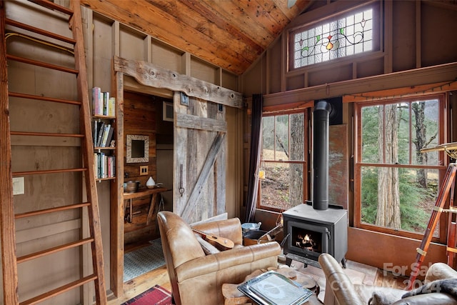 unfurnished room with hardwood / wood-style floors, vaulted ceiling, a wood stove, and wooden ceiling